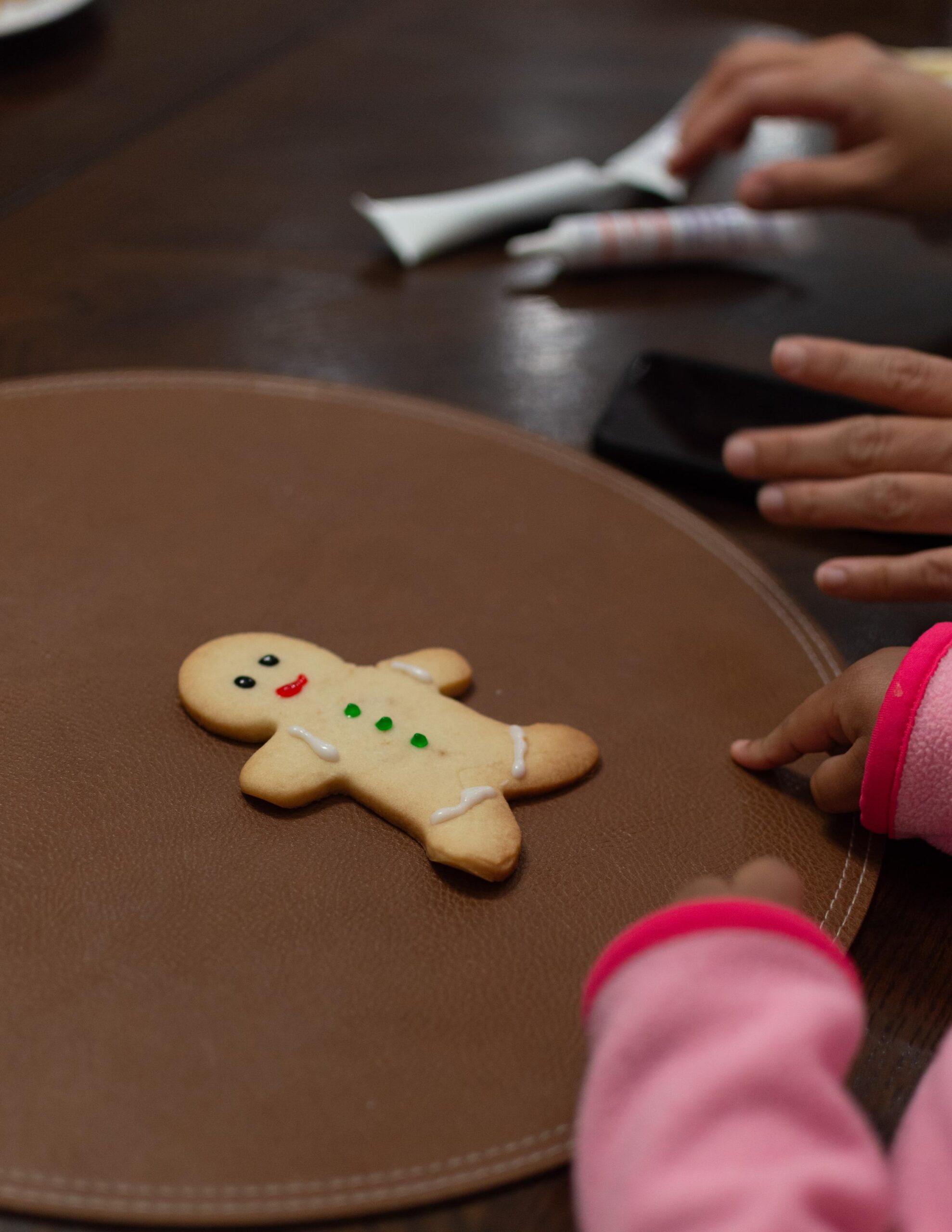 Children Decorating Christmas Cookies at Home.
